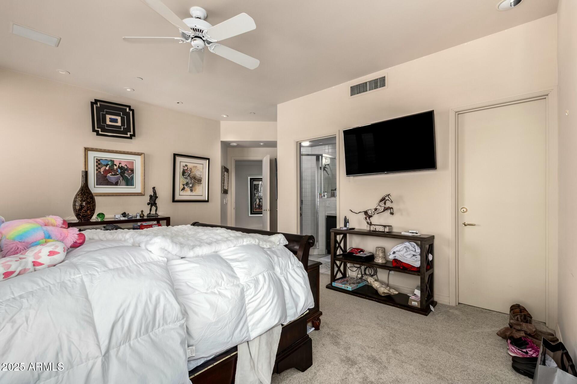 1040 East Osborn Road, Unit 1803 Phoenix, AZ 85014 - Photo 30 of 44 a bedroom with a bed and a flat screen tv