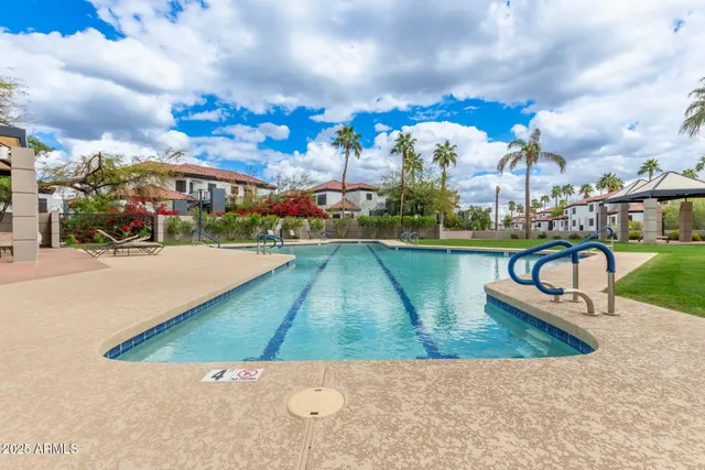 a swimming pool with outdoor seating and yard