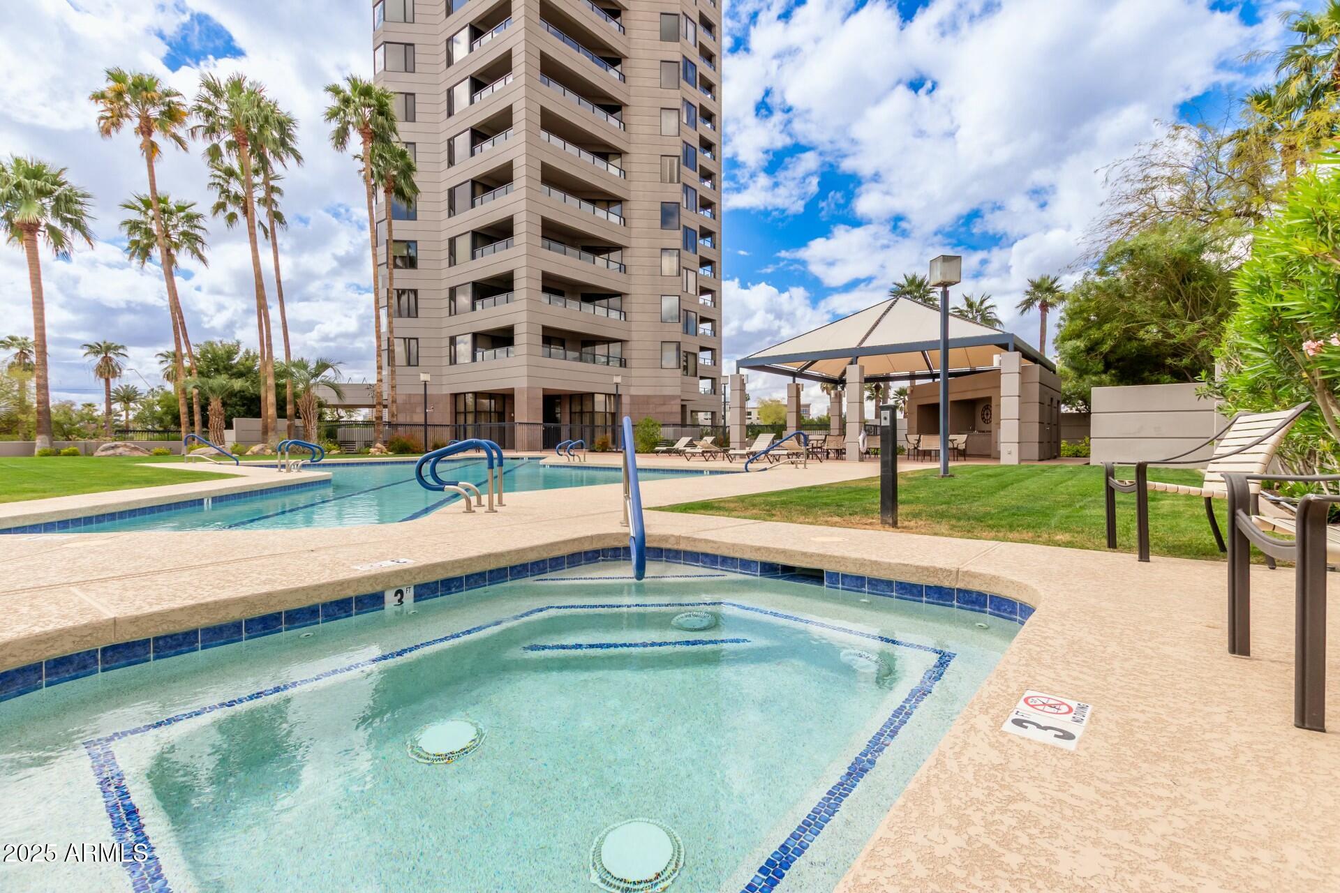 1040 East Osborn Road, Unit 1803 Phoenix, AZ 85014 - Photo 39 of 44 a swimming pool with outdoor seating and yard