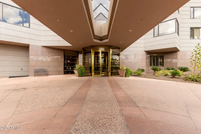 a view of a house with a yard and potted plants