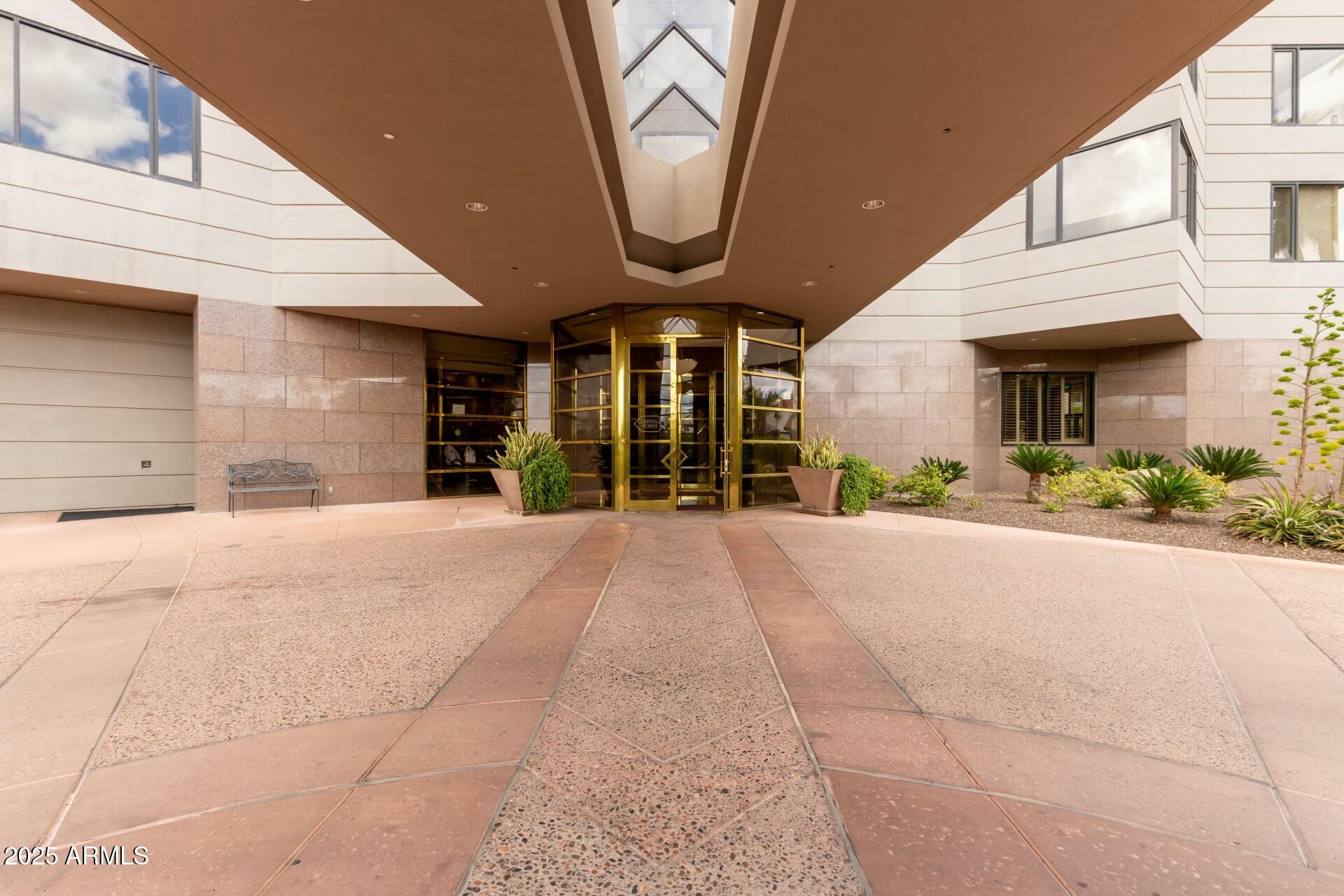 1040 East Osborn Road, Unit 1803 Phoenix, AZ 85014 - Photo 6 of 44 a view of a house with a yard and potted plants