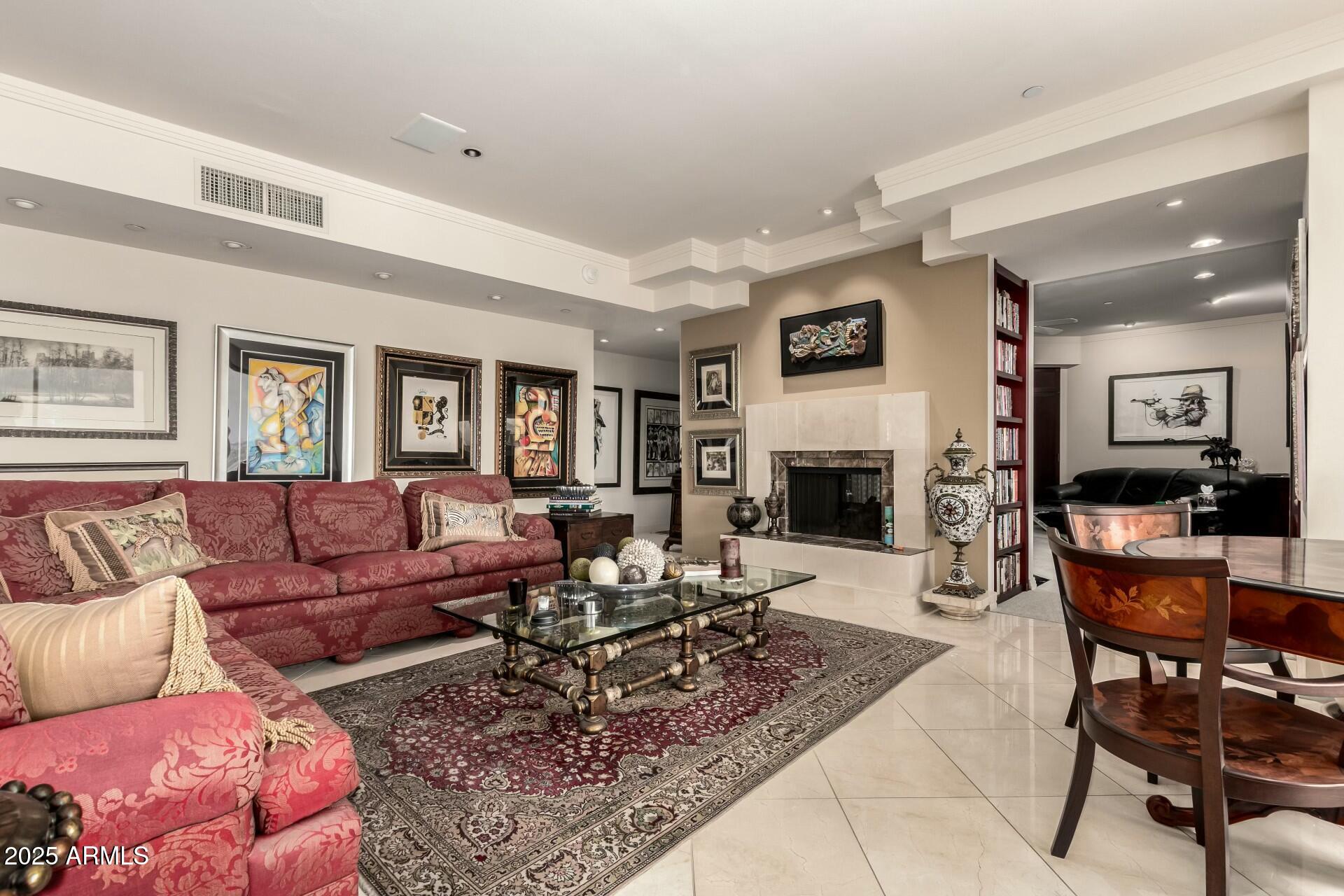 1040 East Osborn Road, Unit 1803 Phoenix, AZ 85014 - Photo 9 of 44 a living room with furniture and a fireplace