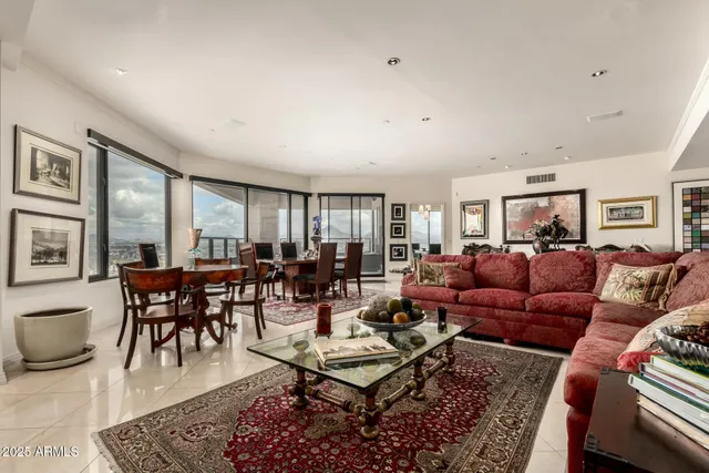 a living room with furniture ceiling fan and a rug