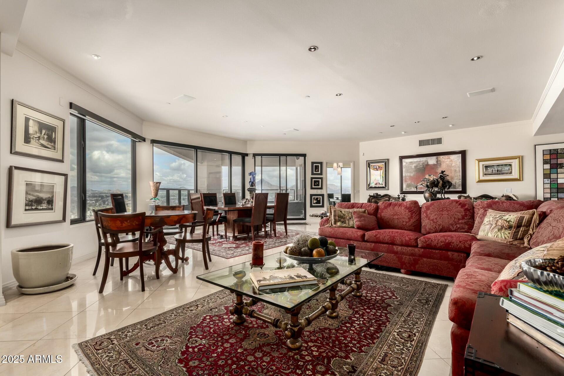 1040 East Osborn Road, Unit 1803 Phoenix, AZ 85014 - Photo 10 of 44 a living room with lots of furniture and a table