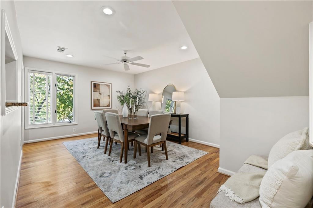 4010 Roswell Road Northeast, Unit 7 Atlanta, GA 30342 - Photo 11 of 36 a view of a dining room with furniture and wooden floor