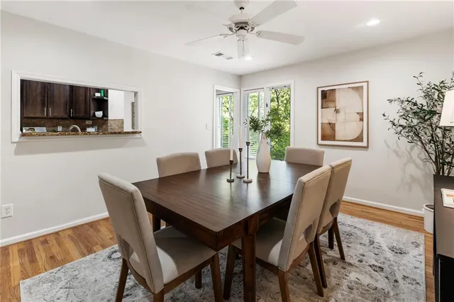 a kitchen with granite countertop stainless steel appliances a sink window and cabinets
