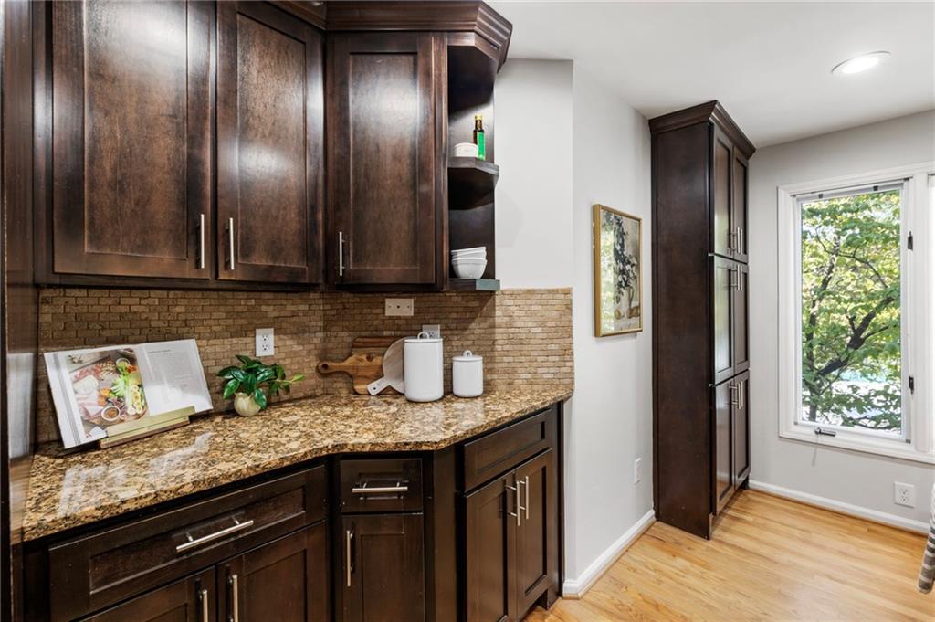 4010 Roswell Road Northeast, Unit 7 Atlanta, GA 30342 - Photo 20 of 36 a kitchen with granite countertop stainless steel appliances wooden cabinets and a granite counter tops
