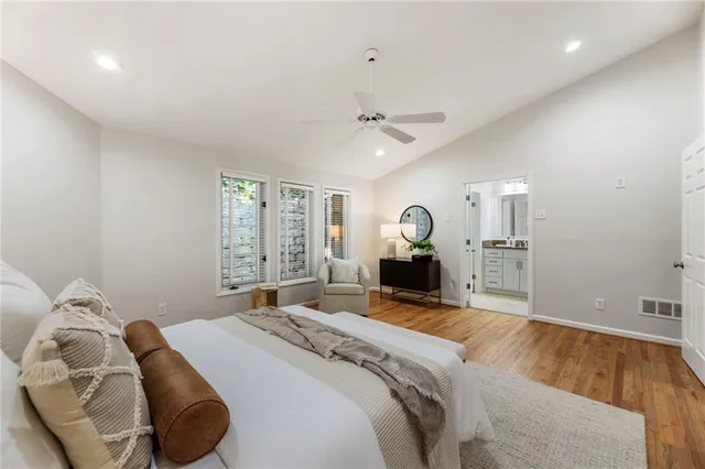 an empty room with a window and ceiling fan