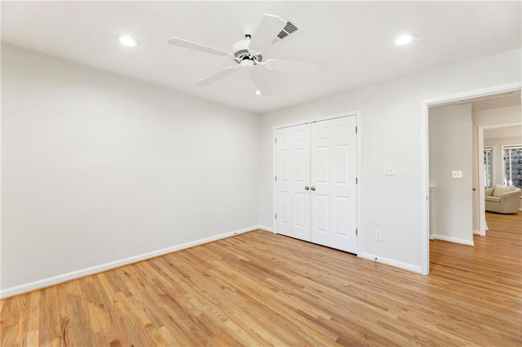 4010 Roswell Road Northeast, Unit 7 Atlanta, GA 30342 - Photo 29 of 36 an empty room with wooden floor and a ceiling fan
