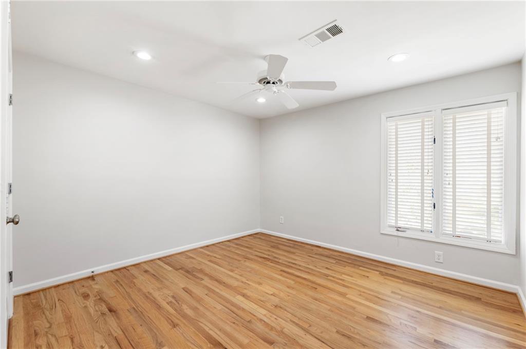 4010 Roswell Road Northeast, Unit 7 Atlanta, GA 30342 - Photo 32 of 36 an empty room with a window and ceiling fan