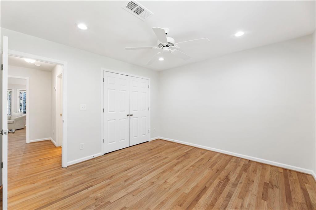 4010 Roswell Road Northeast, Unit 7 Atlanta, GA 30342 - Photo 33 of 36 an empty room with wooden floor and windows