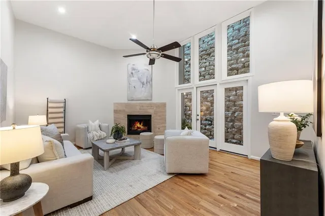 a living room with furniture a fireplace and a chandelier
