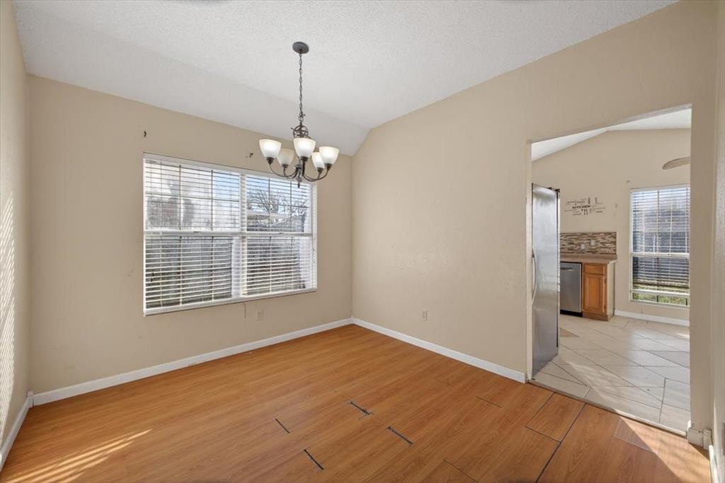 920 Danforth Place Arlington, TX 76017 - Photo 8 of 28 a view of an empty room with kitchen and window