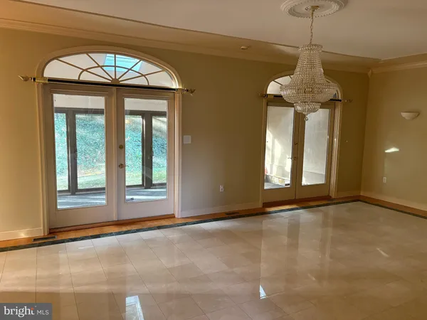 a view of an empty room with window and fireplace