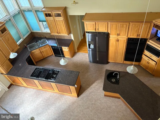 a bathroom with a tub a sink and a window