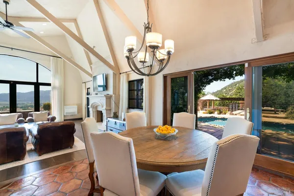 a view of a dining room with furniture large windows and wooden floor