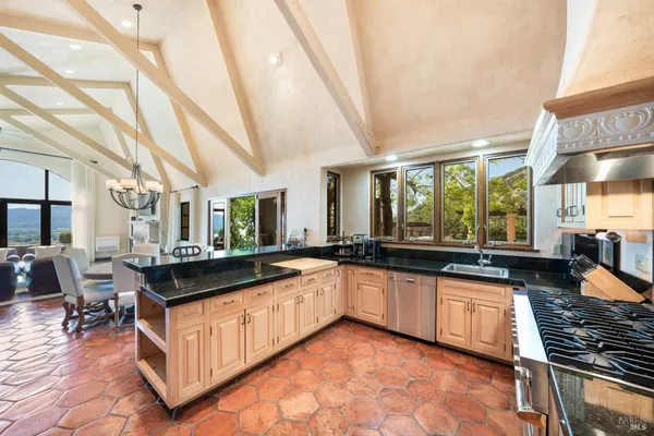 a large kitchen with a stove and cabinets