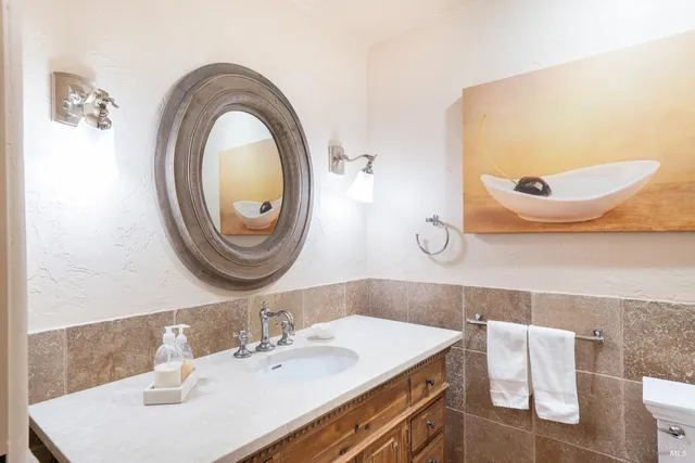 a bathroom with a sink a mirror and a toilet