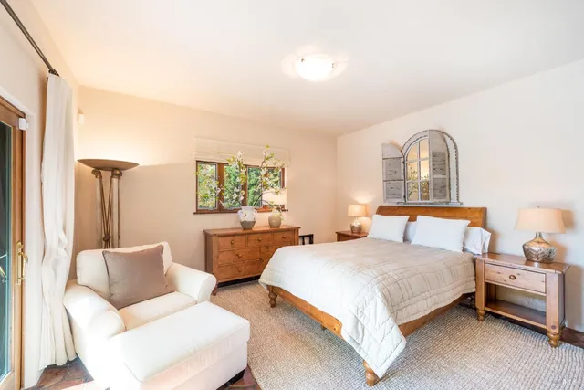 a bedroom with a large bed and a large window