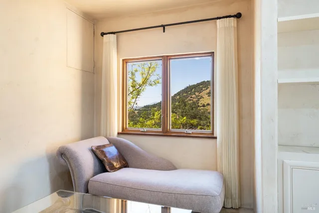 a bedroom with a bed and a large window