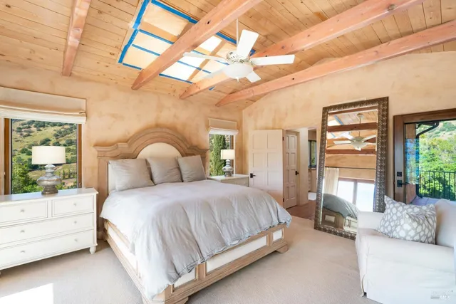 a bathroom with a granite countertop sink a mirror a bathtub and next to a window