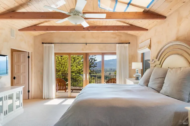 a bedroom with a large bed and a large window