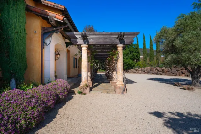 a view of a terrace with furniture and a garden