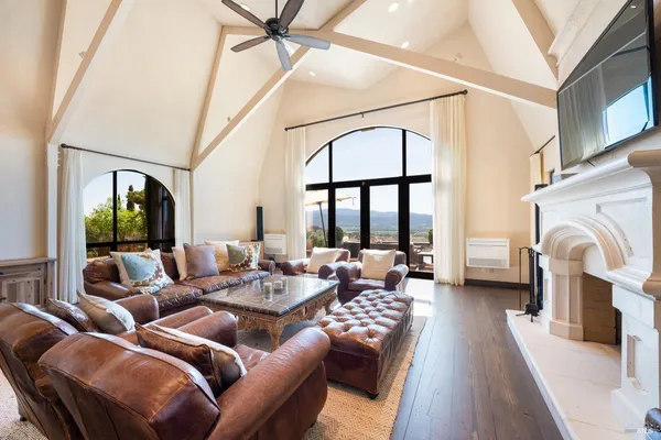 a living room with furniture a large window and a fireplace