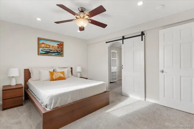 a roof deck with wooden floor and outdoor seating