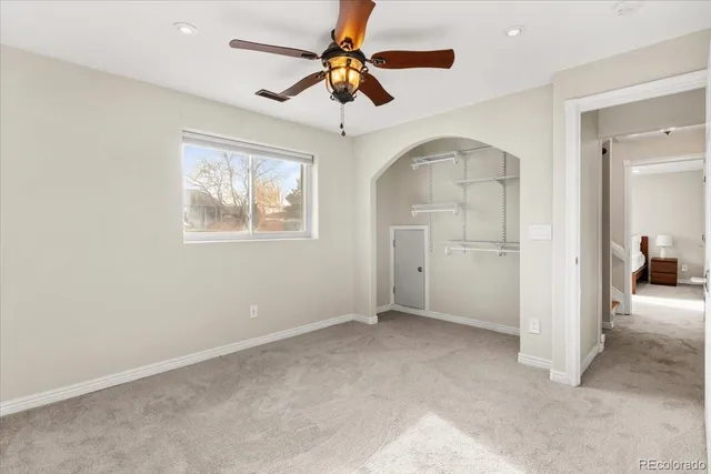 a view of a patio with table and chairs and floor to ceiling window