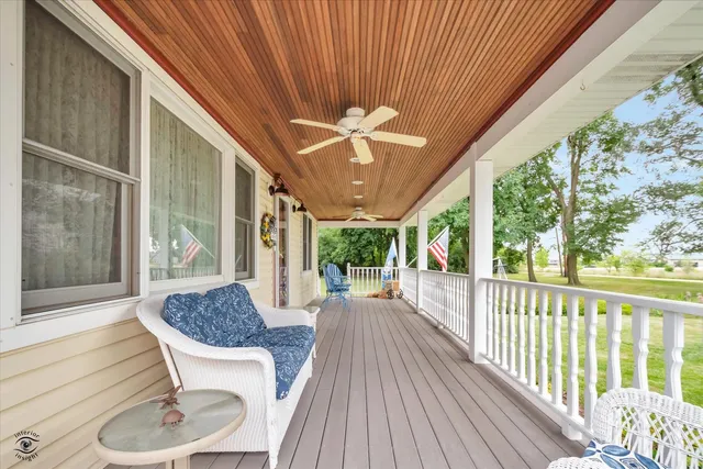 a view of a porch with furniture and a yard