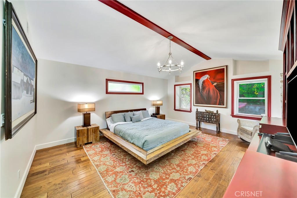 24201 St Edens Circle West Hills, CA 91307 - Photo 18 of 31 a living room with a bed furniture flat screen tv and a large window