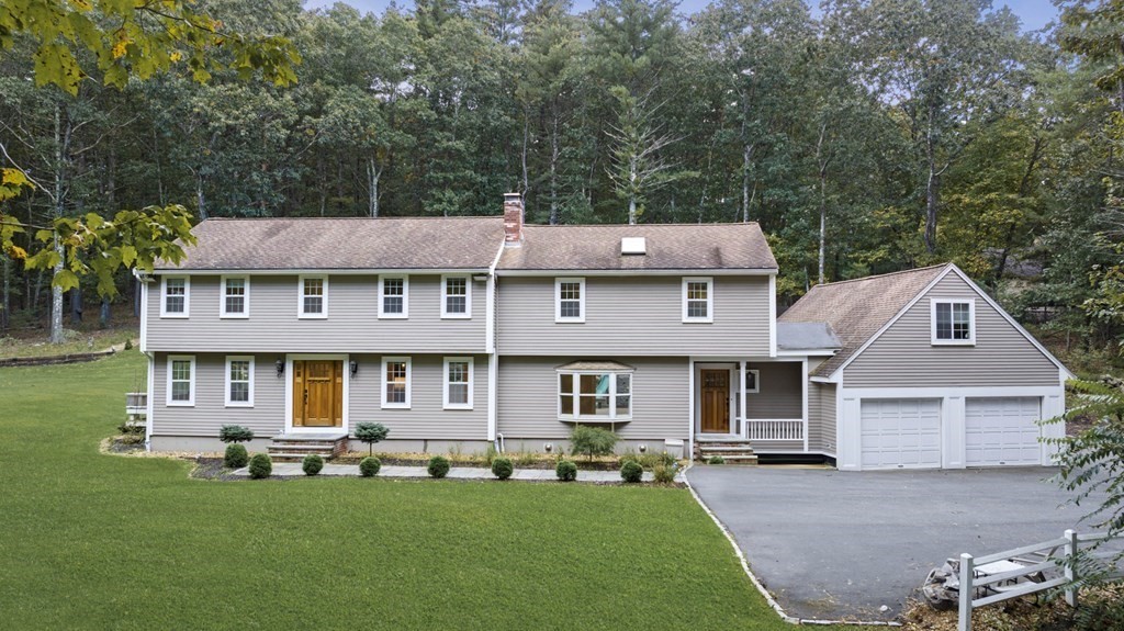 front view of a brick house with a yard