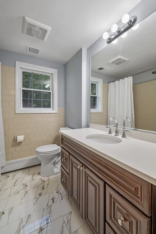 21 Porter Road Boxford, MA 01921 - Photo 23 of 42 a bathroom with a sink a toilet and a mirror