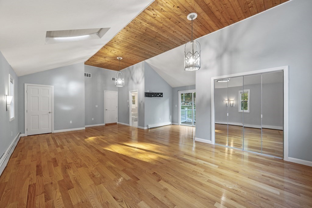21 Porter Road Boxford, MA 01921 - Photo 31 of 42 a view of an empty room with wooden floor and a kitchen