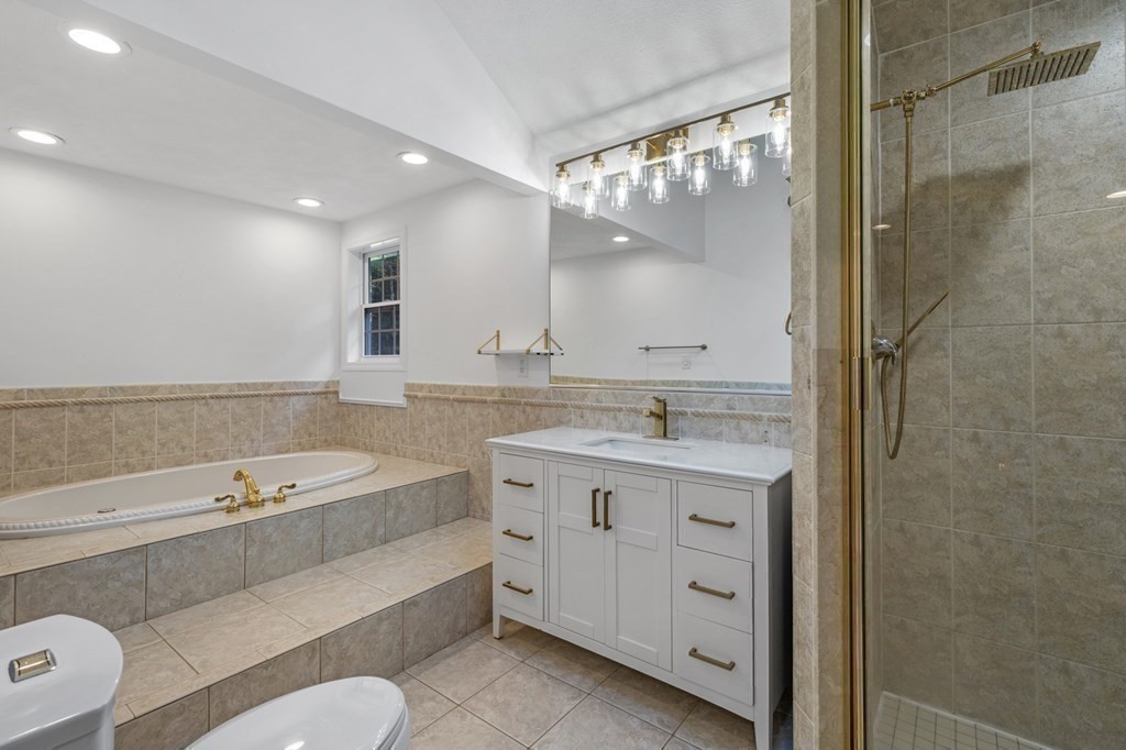 21 Porter Road Boxford, MA 01921 - Photo 33 of 42 a bathroom with a tub a sink and mirror