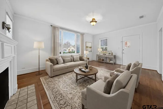 wooden floor fireplace and windows in an empty room