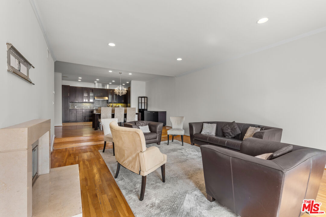 1260 South Beverly Glen Boulevard, Unit 305 Los Angeles, CA 90024 - Photo 16 of 28 a living room with furniture and a table