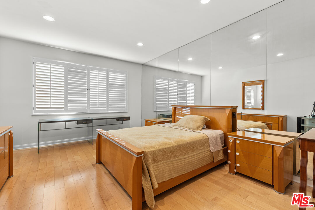 1260 South Beverly Glen Boulevard, Unit 305 Los Angeles, CA 90024 - Photo 22 of 28 a bedroom with a bed and a table