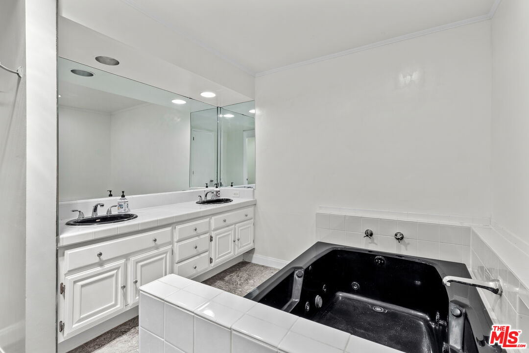 1260 South Beverly Glen Boulevard, Unit 305 Los Angeles, CA 90024 - Photo 26 of 28 a kitchen with a sink and cabinets