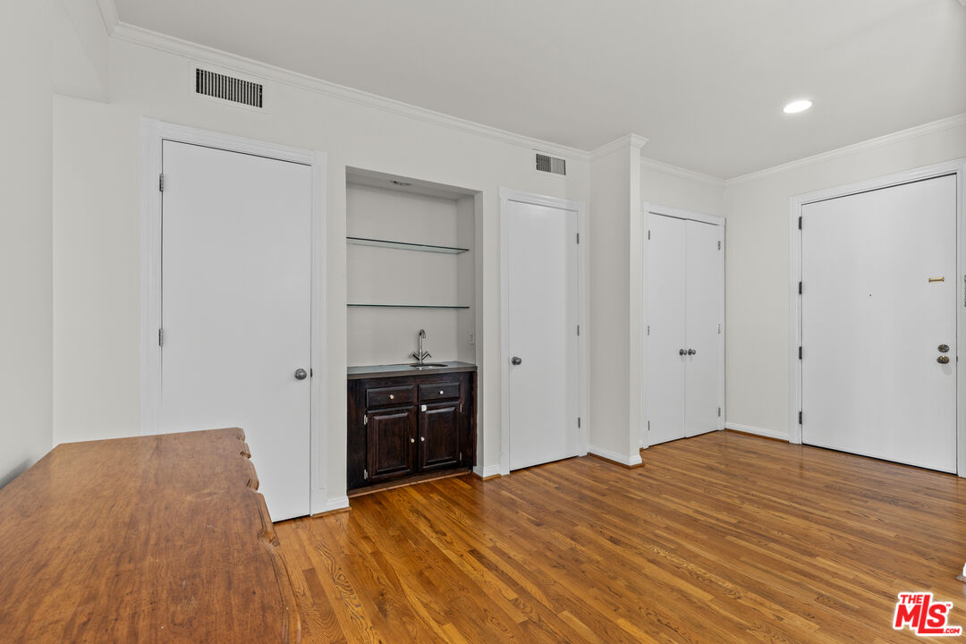 1260 South Beverly Glen Boulevard, Unit 305 Los Angeles, CA 90024 - Photo 8 of 28 a bedroom with a bed and a dresser