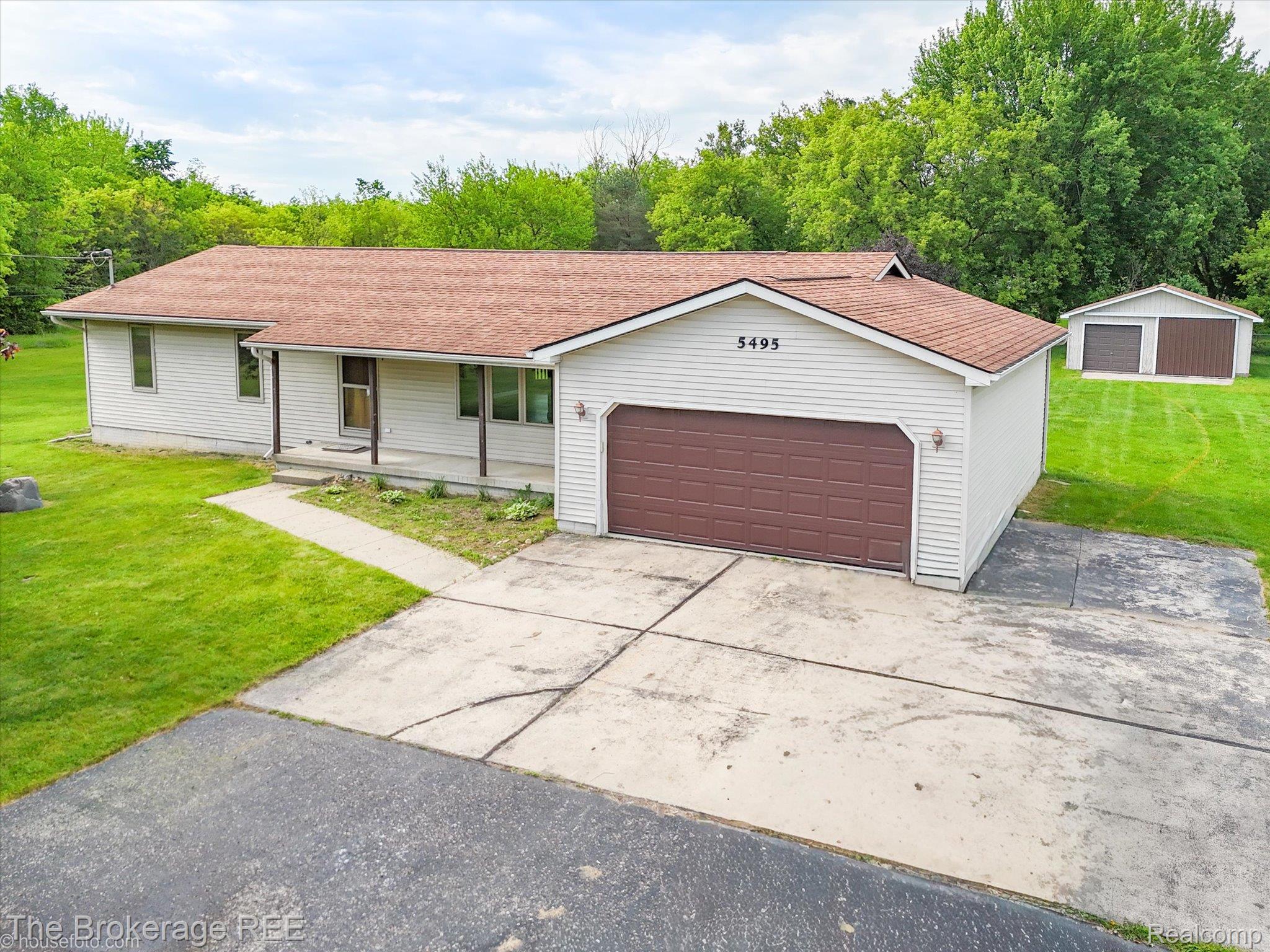 5495 East Coldwater Road Flint, MI 48506 - Photo 2 of 44 Ranch-style residence featuring light-colored siding and a brown shingle roof