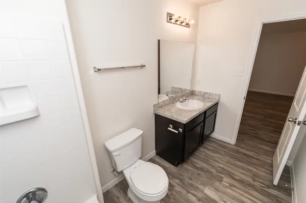 a bathroom with a toilet a sink and a mirror