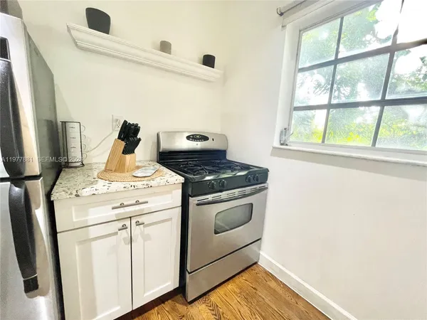 a stove top oven sitting inside of a kitchen