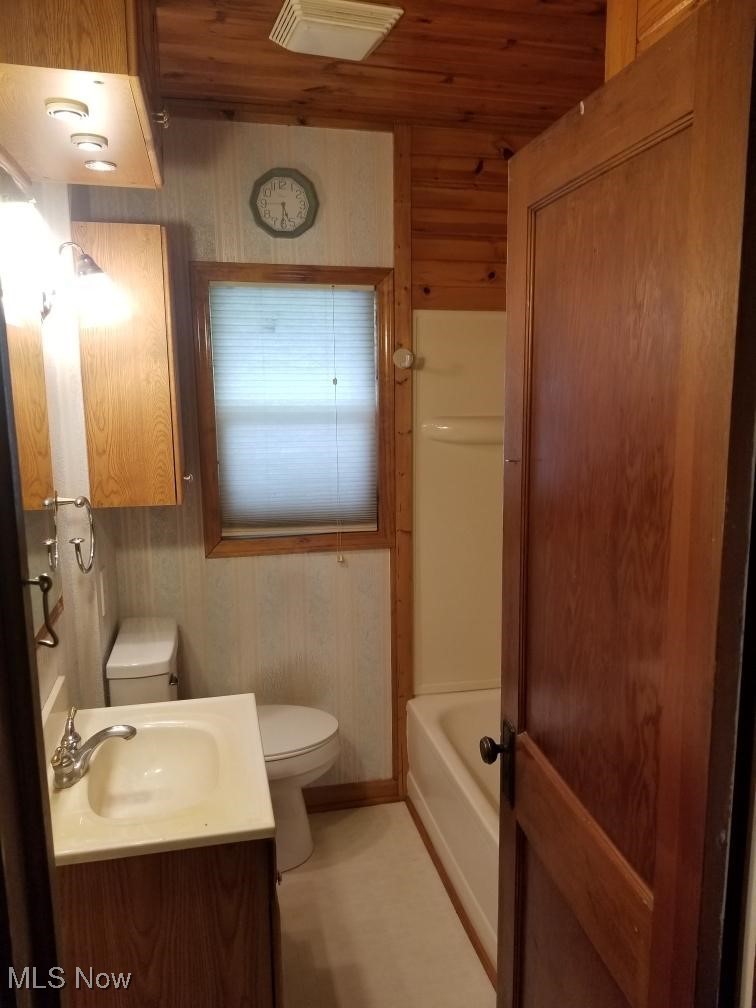 218 Canton Road Akron, OH 44312 - Photo 17 of 19 Bathroom featuring washtub / shower combination, wood ceiling and walls