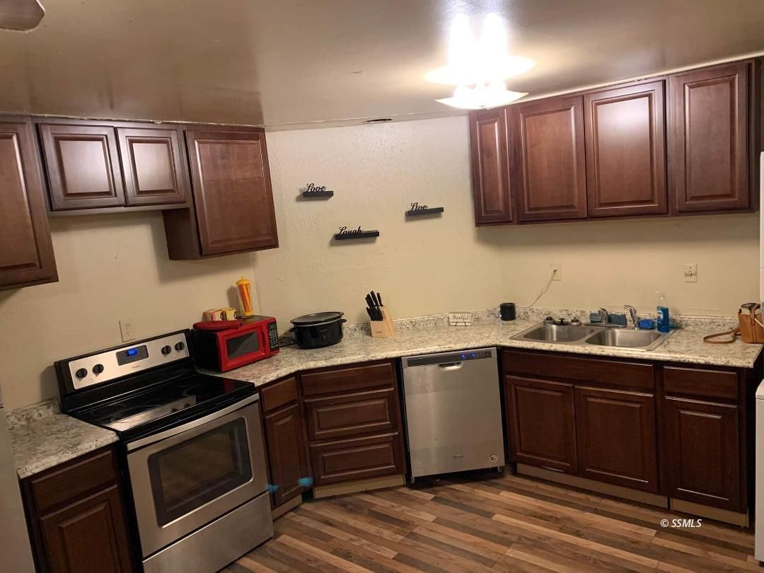 238 South Warner Street Ridgecrest, CA 93555 - Photo 9 of 15 a kitchen with cabinets a sink and appliances