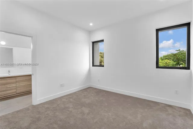 an empty room with a painting on the wall