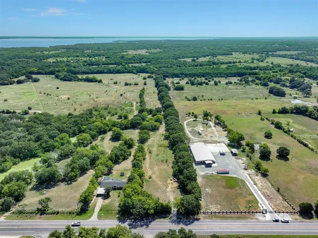 an aerial view of a houses with a yard