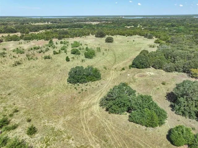 a view of a field with an ocean view