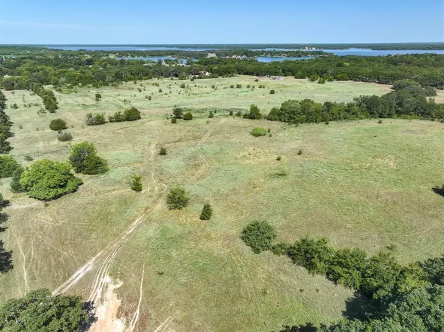 an aerial view of a houses with a yard